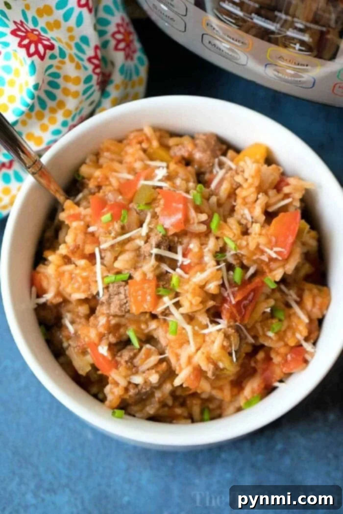 Instant Pot Stuffed Pepper Casserole with ground beef and melted cheese, garnished with fresh herbs.