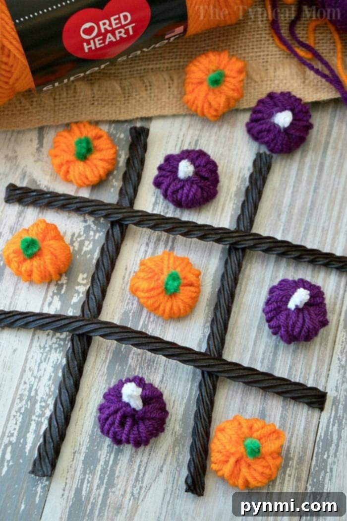 kids playing Halloween Tic Tac Toe with yarn pumpkins