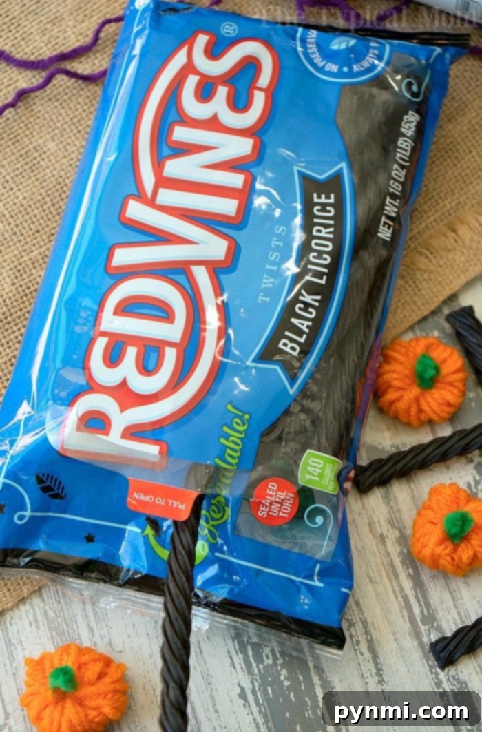 kids playing tic tac toe with yarn pumpkins and licorice