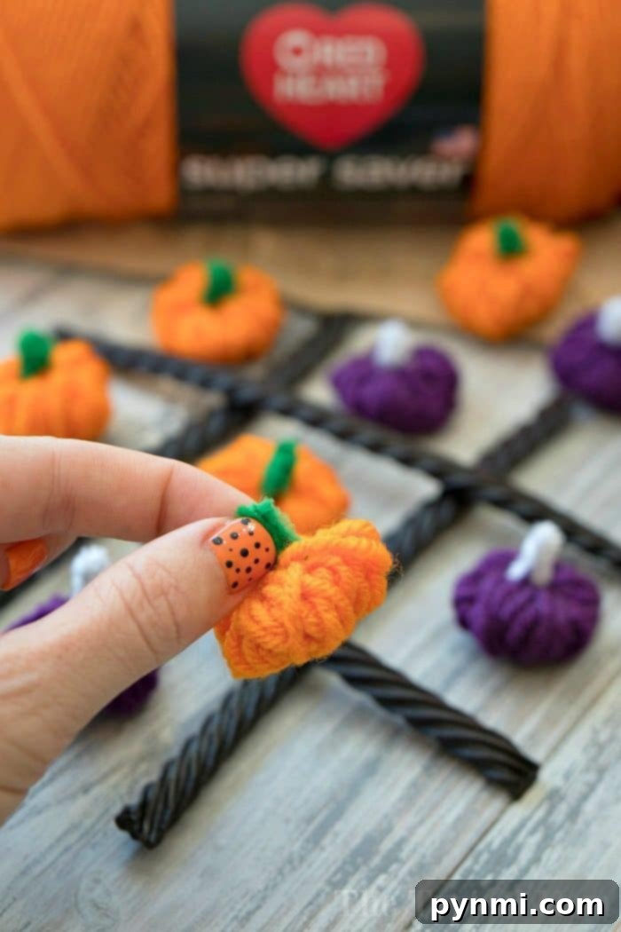 finished yarn pumpkin craft with licorice game board