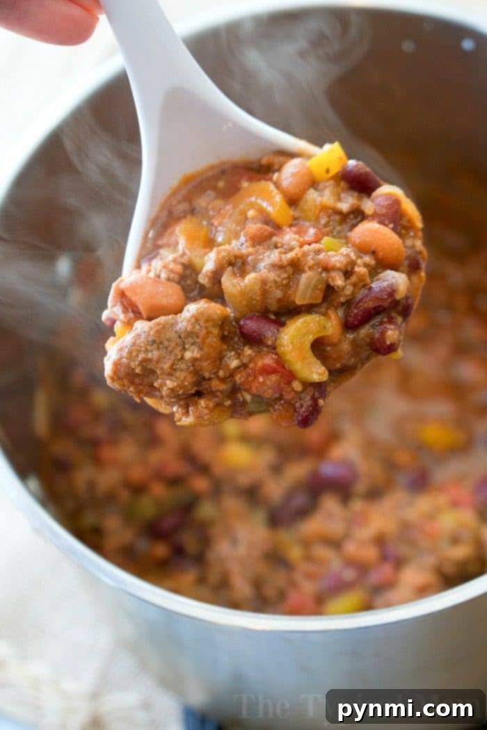 Easy Bloody Mary Chili recipe in a serving bowl, garnished with fresh herbs