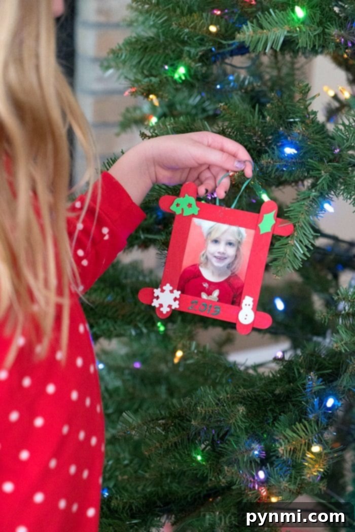 A close-up of a festive artificial Christmas tree with bright, color-changing lights illuminating ornaments.