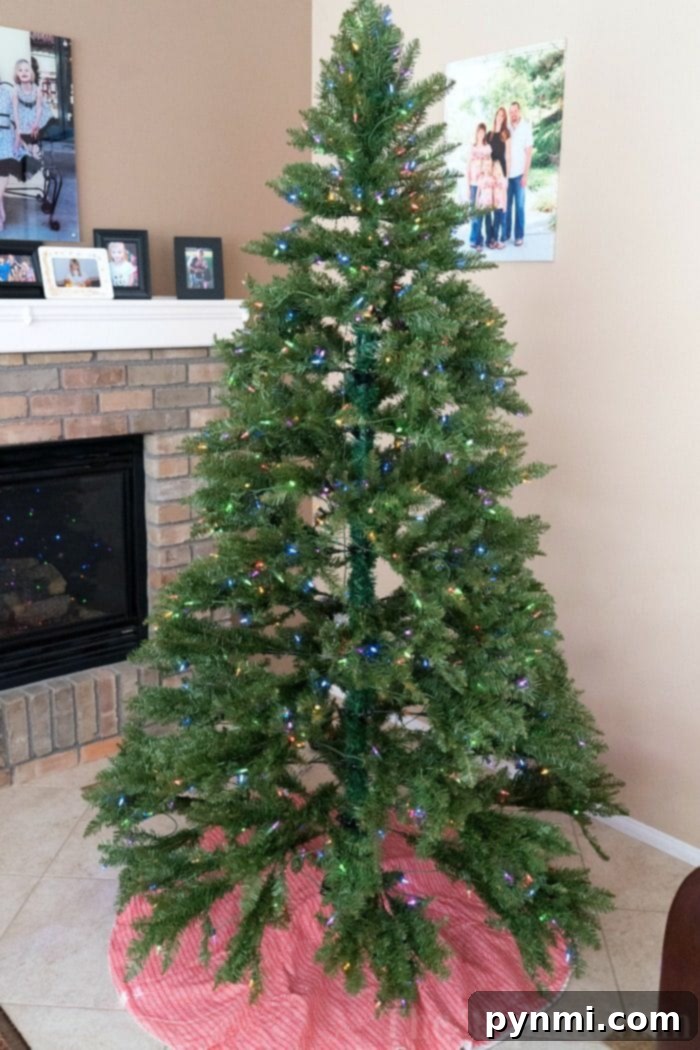 A festive holiday living room scene featuring a decorated artificial Christmas tree and cozy ambiance.