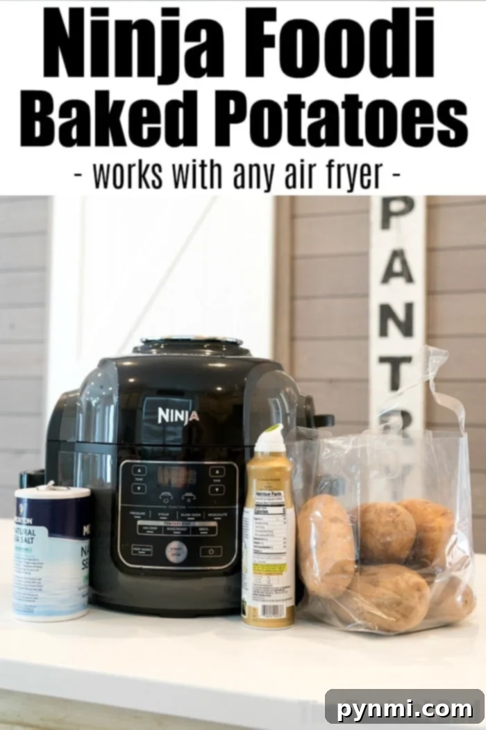 Ninja Foodi baked potatoes in a bag sit on the counter with salt and oil beside a Ninja air fryer. "Ninja Foodi Baked Potatoes" is written above, highlighting this simple and delicious method.