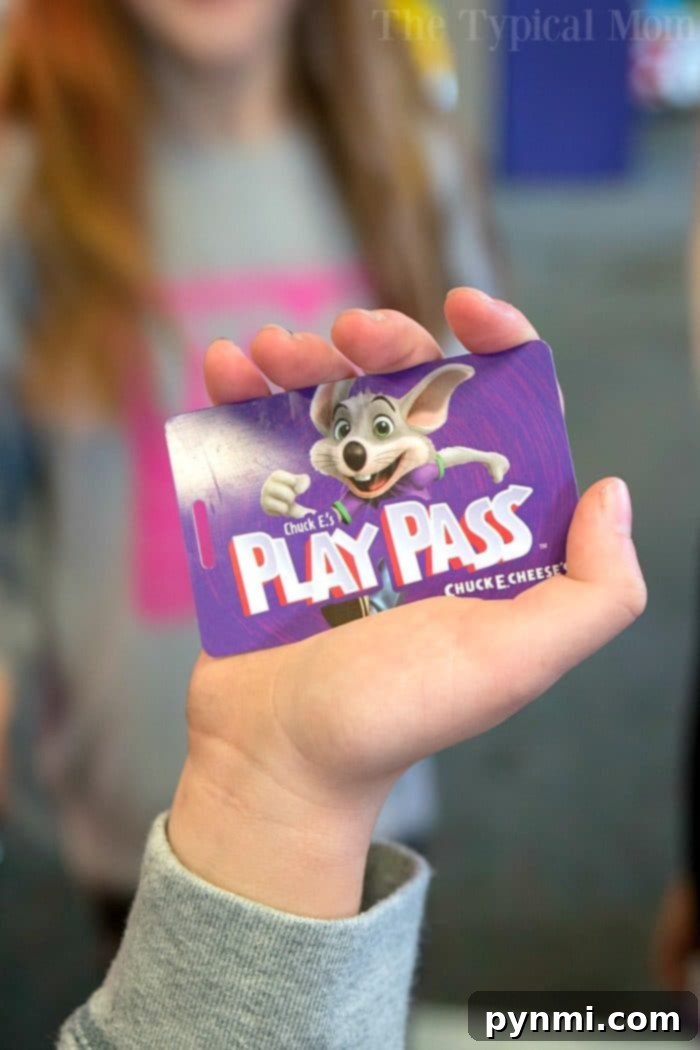 A child joyfully collecting tickets from a game at a Chuck E. Cheese birthday party, excited for prizes.