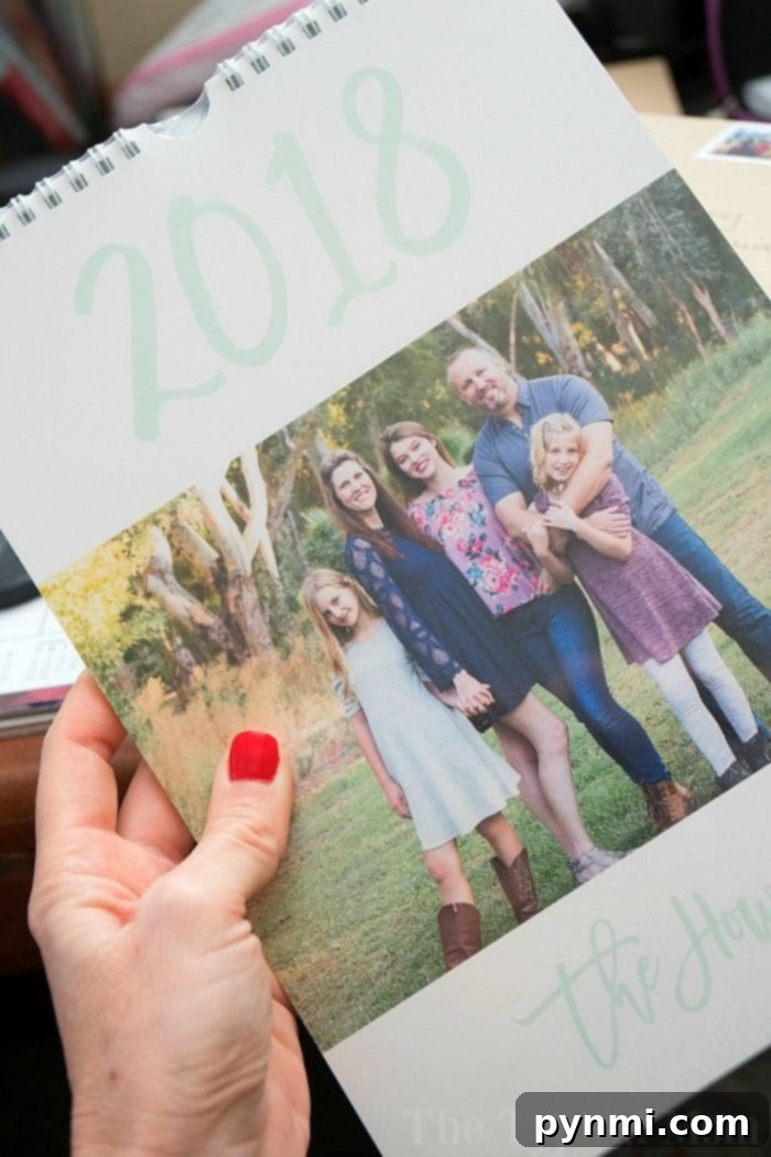 Custom Postage Design Your Own Stamps 4 A person holds a personalized calendar featuring a family portrait outdoors, inspiring the idea to create your own postage stamp with cherished moments.