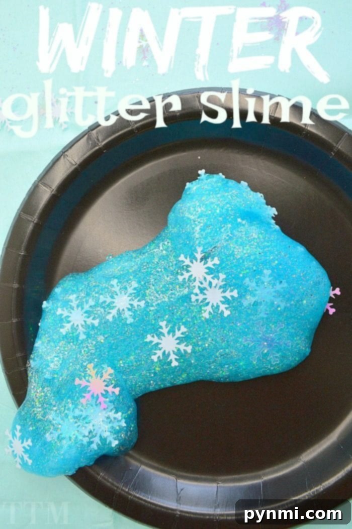 A child's hands playing with stretchy, translucent blue slime, perfect for sensory exploration.