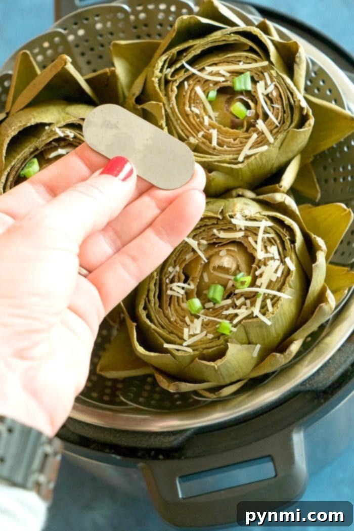 Easy Instant Pot artichokes with creamy dill dipping sauce ready in less than 15 minutes! How to steam artichokes in your pressure cooker to perfection. Our favorite vegetable for dinner and a healthy side dish too. #instantpot #pressurecooker #vegetables #artichokes #artichoke #instantpotrecipes #thetypicalmom #vegetarian Easy Instant Pot Artichokes 2