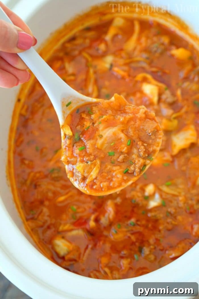 Hearty and simple slow cooker unstuffed cabbage soup with ground sausage, an ultimate comfort food recipe for any season. A close-up of slow cooker unstuffed cabbage soup, showcasing the rich, savory broth, tender cabbage, and seasoned ground sausage.