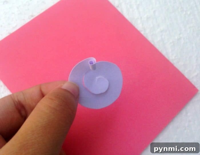 Crafting a Pop Up Heart Card 4 Step-by-step image demonstrating the initial cut of a paper circle and beginning the spiral cut for a paper flower