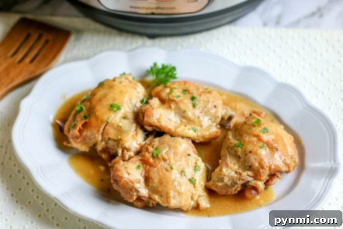 Perfectly cooked pressure cooker boneless chicken thighs, glistening with sauce and ready to be served as a delightful meal.