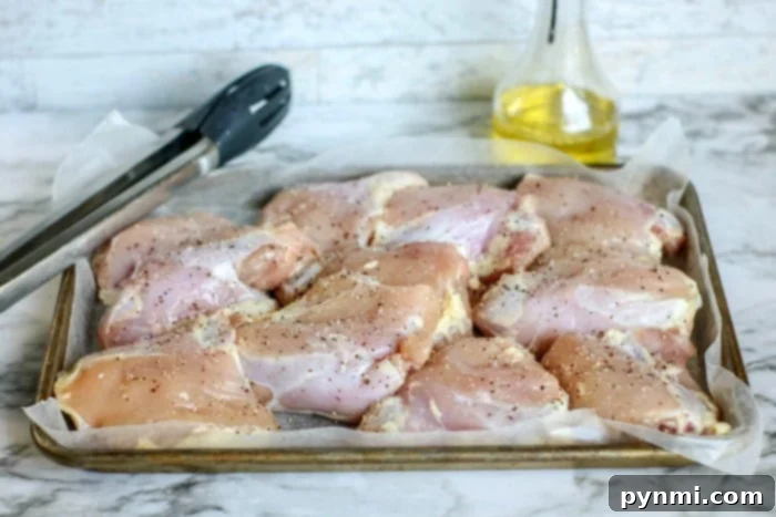 Overhead view of chicken thighs being sautéed to a golden brown in an Instant Pot before the pressure cooking phase, building foundational flavors.