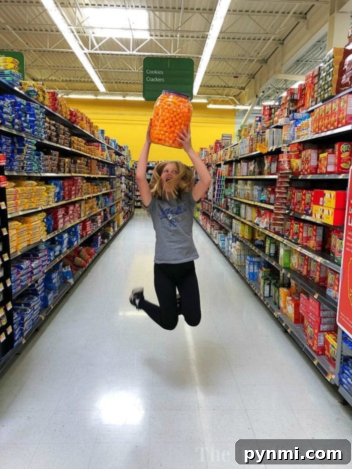 Aisle Adventure Hunt 5 Humorous image of a child in a grocery cart surrounded by a pile of snacks, representing the overwhelming challenge of shopping with kids.