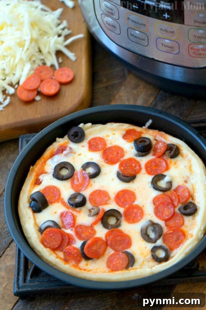 Perfect Instant Pot Pizza Slice A close-up of a delicious Instant Pot pizza slice, showing off its rich layers of melted cheese and savory toppings, pulled from the deep dish for serving.