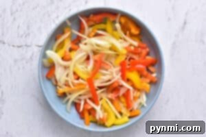 Zesty Instant Pot Salsa Chicken 4 Sliced bell peppers and onions, ready to be added to the Instant Pot salsa chicken.