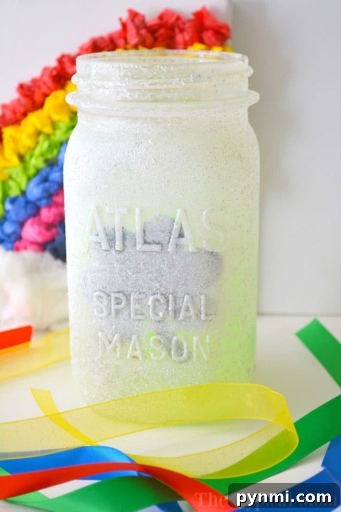 These fun and inexpensive mason jar luminaries are perfect for any holiday or classroom project, or as DIY nightlights for your child's room. Two completed mason jar luminaries, one green with a shamrock and one blue, ready for display.