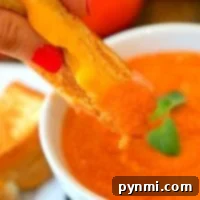 A perfectly portioned bowl of creamy tomato soup, ready to serve.
