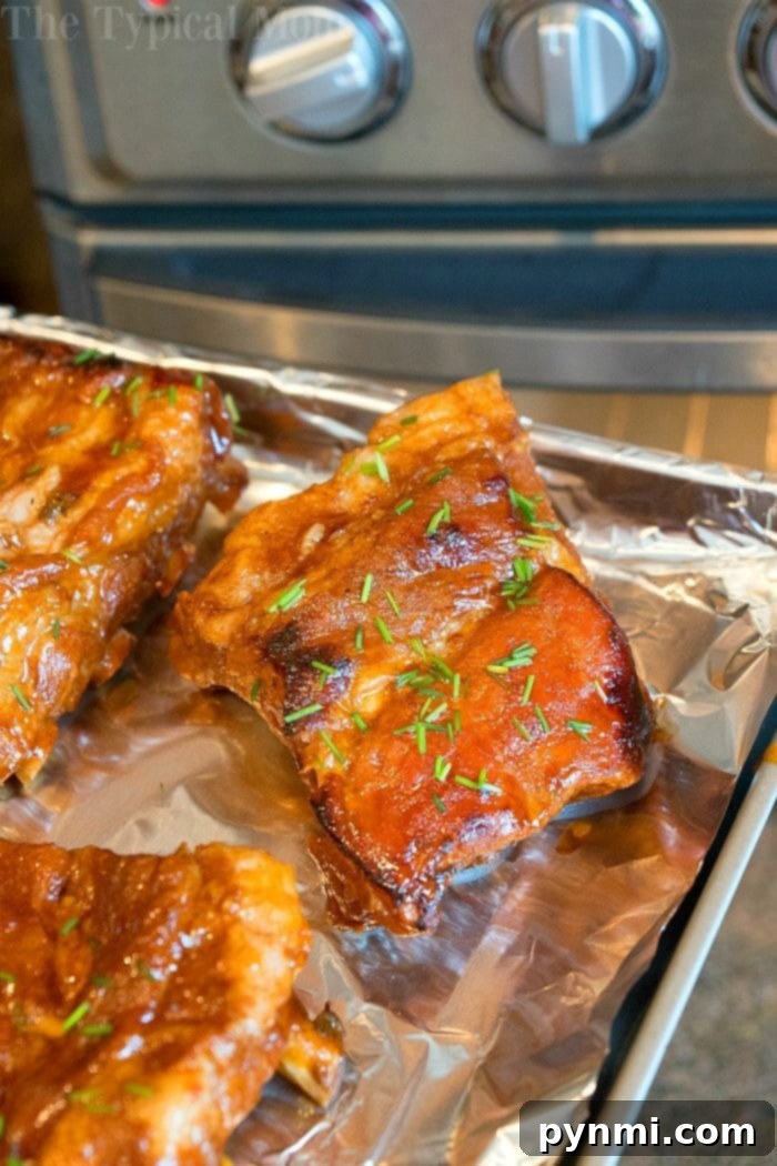 Fall-Off-The-Bone Express Ribs 5 A plate of perfectly cooked Crockpot Express ribs, beautifully glazed and ready to be served.