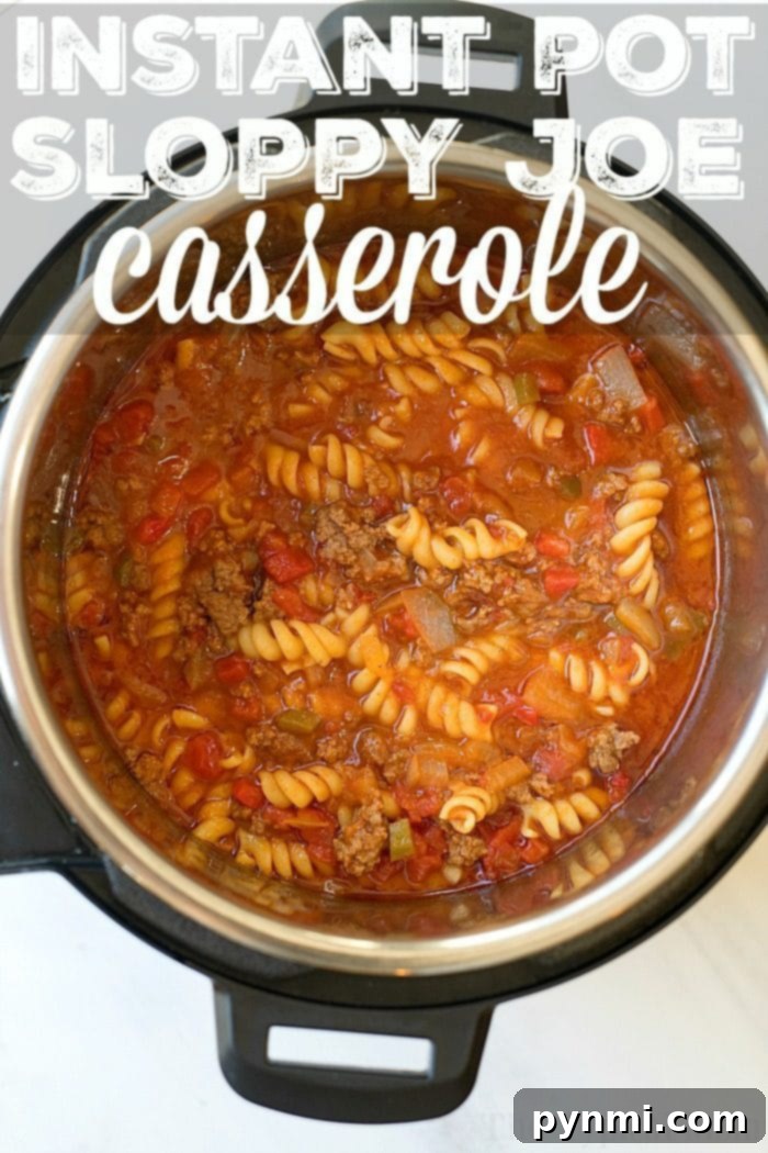 Hearty Instant Pot Sloppy Joe Casserole: A family-friendly dinner featuring savory sloppy joe sauce with pasta, ground beef, and cheese, all made efficiently in a pressure cooker. #sloppyjoes #casserole #instantpot #pressurecooker #groundbeef #instantpotrecipes #thetypicalmom Delicious Instant Pot Sloppy Joe Casserole, a one-pot meal with rotini pasta, ground beef, and rich tomato sauce, topped with melted cheese, served in a pressure cooker.