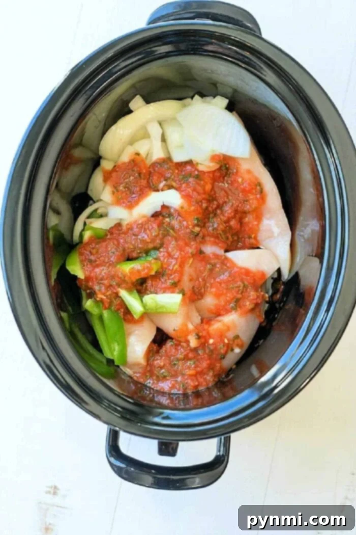 Set and Forget Salsa Chicken 5 Frozen boneless skinless chicken breasts and a jar of salsa inside a crockpot, illustrating the ease of starting this recipe from frozen.