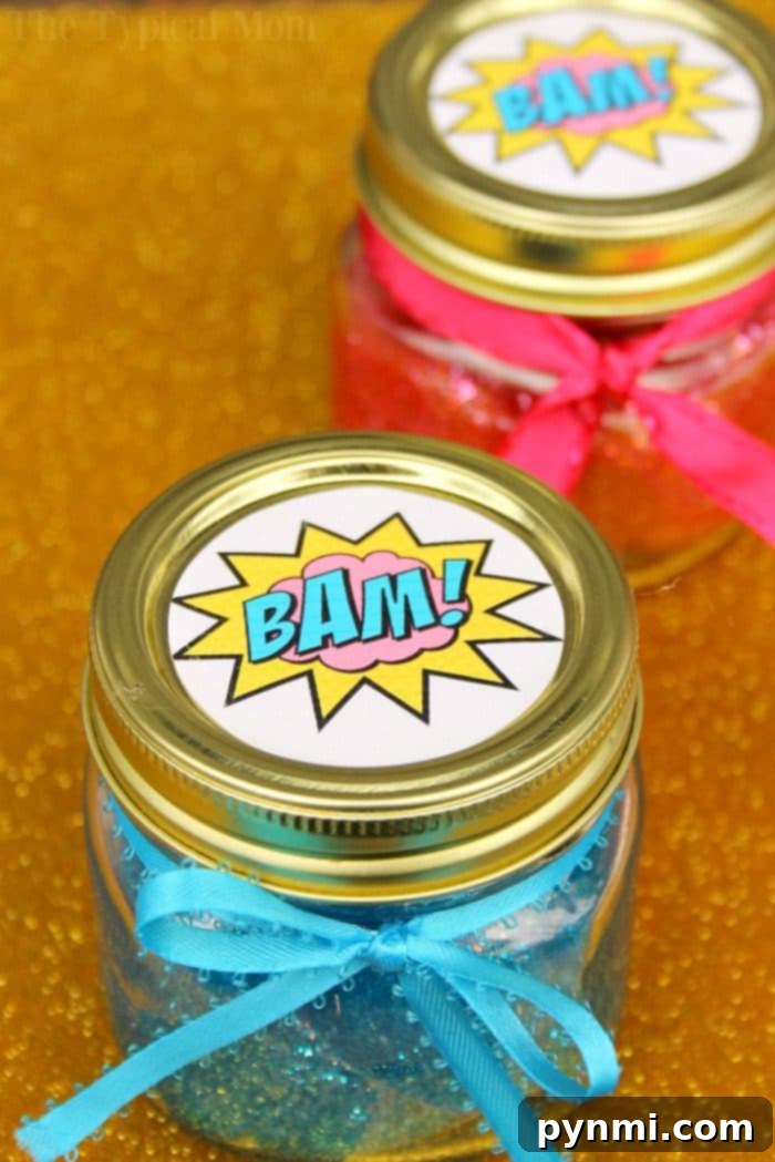 Unlocking Marvel Superpowers with Slime 5 A child's hands stretching out vibrant blue glitter slime, demonstrating its perfect texture.