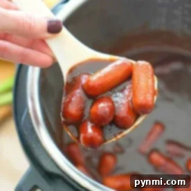 A ladle serving delicious Instant Pot cocktail wieners from the pot.