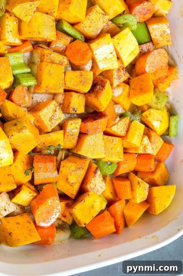 This homemade butternut squash soup is a delightful comfort food that evokes childhood memories, making it a perfect year-round meal. With fresh squash and other vegetables, you can easily create this smooth, nutritious vegetarian soup for dinner, a dish that even children are guaranteed to love. It’s a healthy and flavorful complete meal, all served in one satisfying bowl. #squash #soup #vegetarian #homemade #butternut A second close-up view of the homemade Butternut Squash Carrot Soup, beautifully presented in a bowl, highlighting its smooth, inviting texture and vibrant color, ready to be garnished.