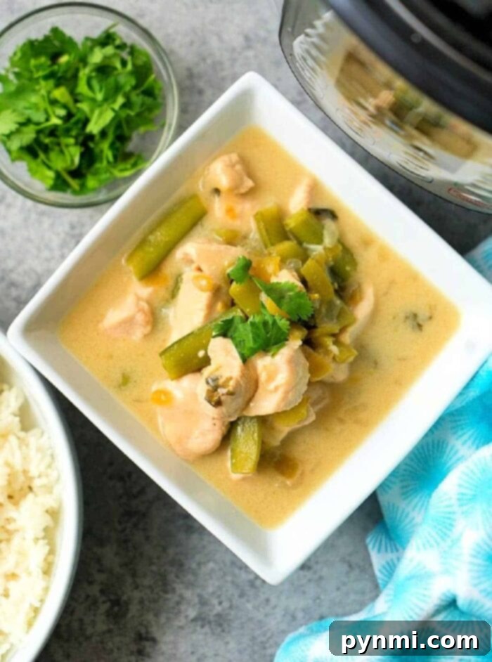 Creamy Coconut Chicken 5 A close-up of a pressure cooker filled with ingredients for coconut chicken, including chicken, vegetables, and spices, before cooking, highlighting the ease of making this dairy-free meal in an Instant Pot.