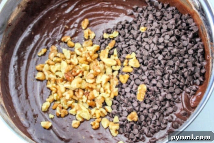 Fudgy Devils Food Cake Mix Brownies 3 Rich chocolate batter for Devil's Food brownies with chopped walnuts and chocolate chips in a mixing bowl.