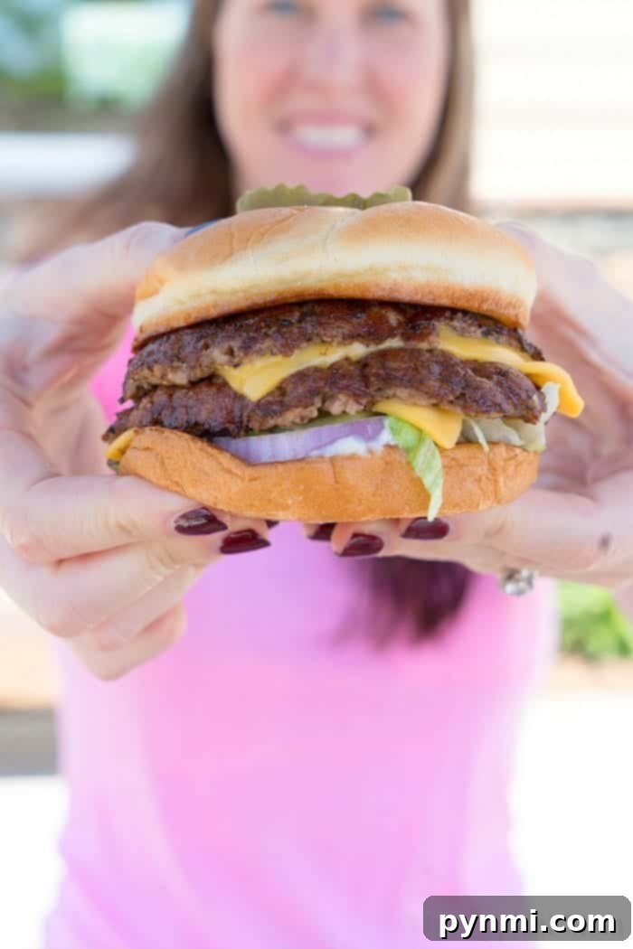 Culver's ButterBurger: A Culinary Delight for National Hamburger Month A delicious Culver's ButterBurger with crispy cheese curds and a drink, ready to be enjoyed.