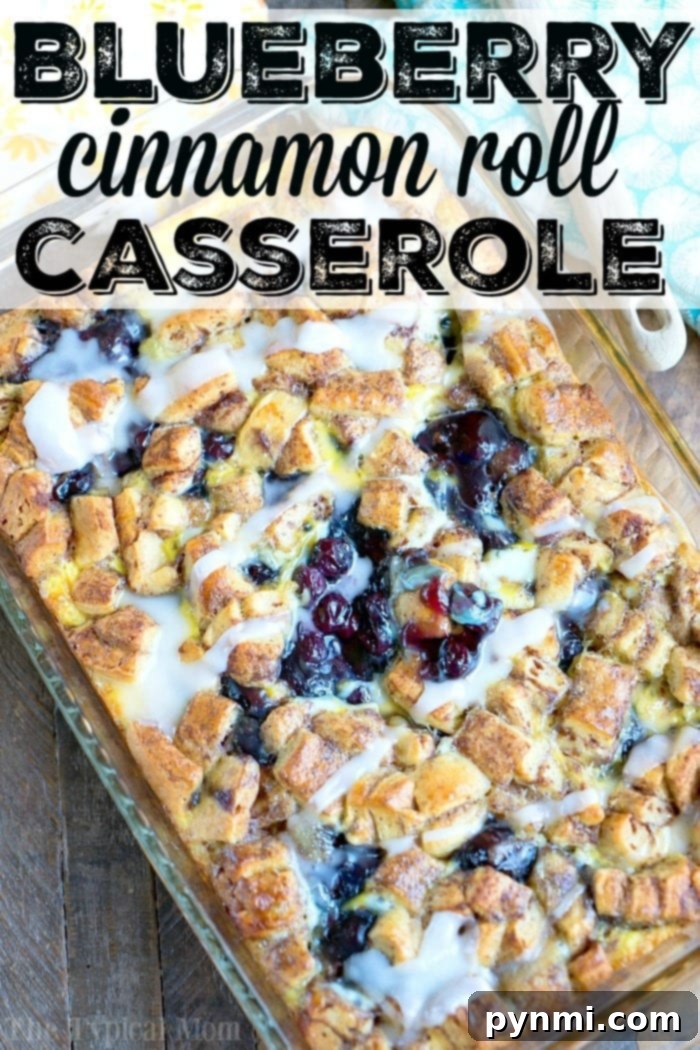 This easy cinnamon roll breakfast casserole with blueberries is just amazing! Served for brunch or on Christmas morning it is a great way to make cinnamon rolls into a fruit casserole that everyone will love. Feeds 12 and costs under $10 to make which is a winner in my book! #cinnamonroll #casserole #breakfast #blueberry #fruit #easy Cinnamon Roll Breakfast Casserole ready to serve
