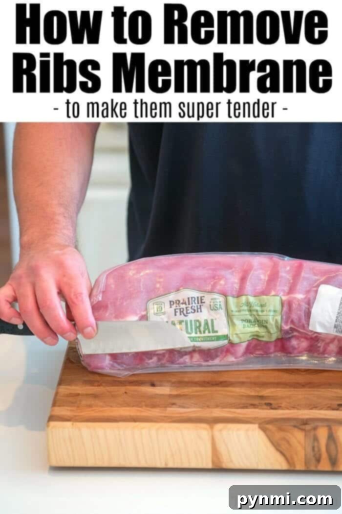 Close-up of ribs with a membrane being peeled off, illustrating the key step for tender ribs.