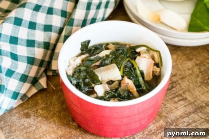 Instant Pot spinach is a great side dish recipe to make for your family. Add bacon and it's great. #instantpot #instantpotrecipes #spinach #vegetable #sidedish #healthy #thetypicalmom A large serving bowl filled with a generous portion of cooked pressure cooker spinach.