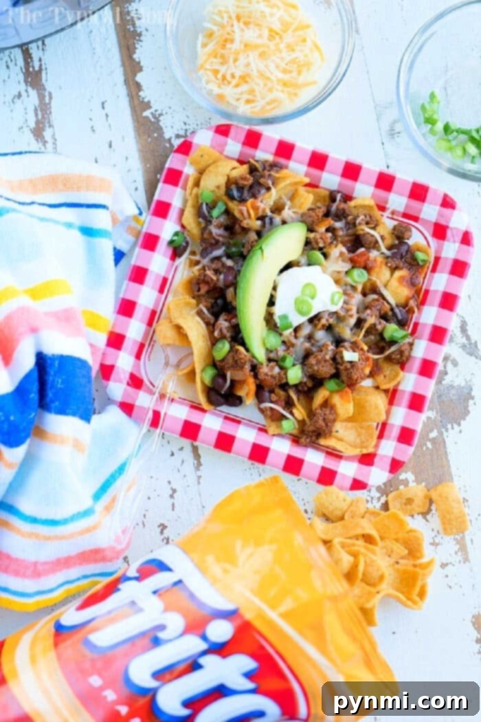 Frito chili pie recipe cooked in an Instant Pot, showing a serving with various toppings.