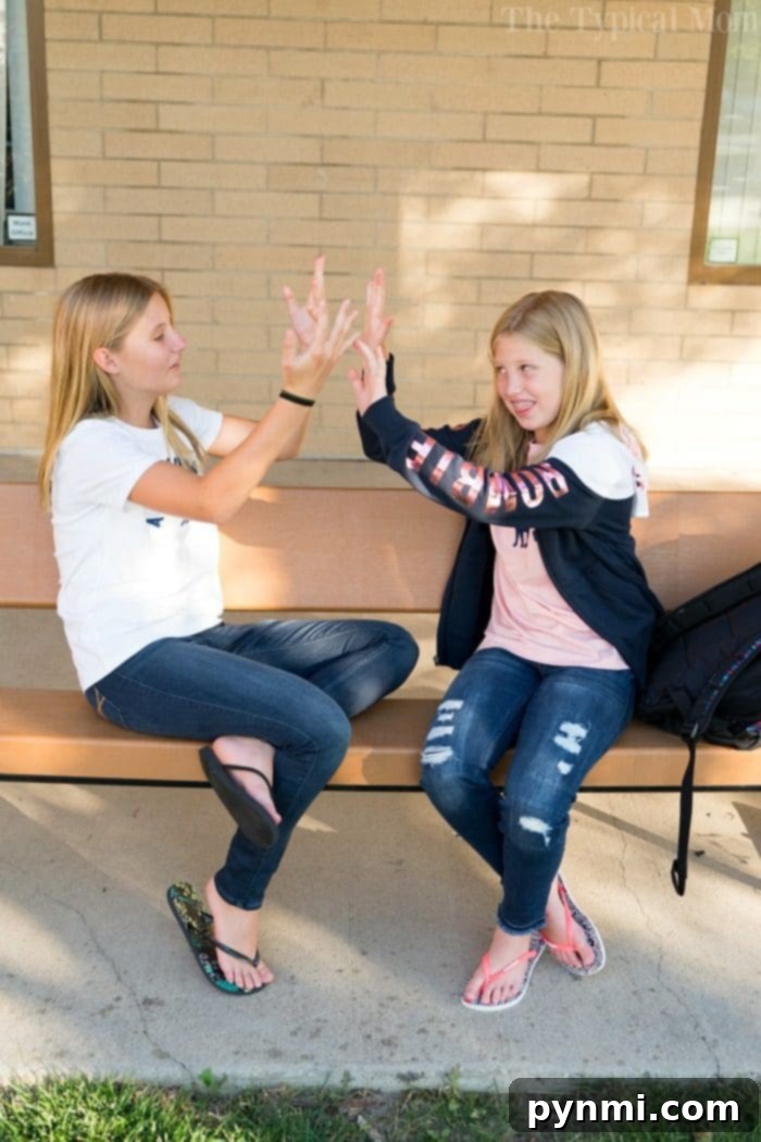 Kids' jeans that offer comfort and durability for both school activities and lively weekend play. Two girls wearing comfortable Abercrombie Kids jeans for school and play