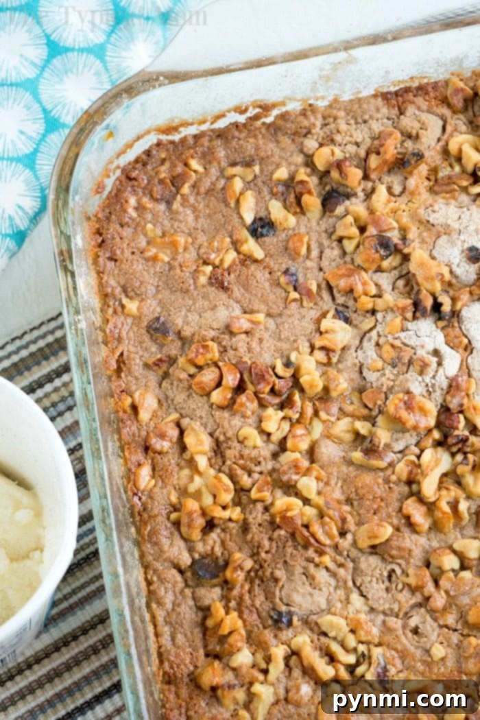 Easy pumpkin cake with a golden crust, served in a square baking dish.