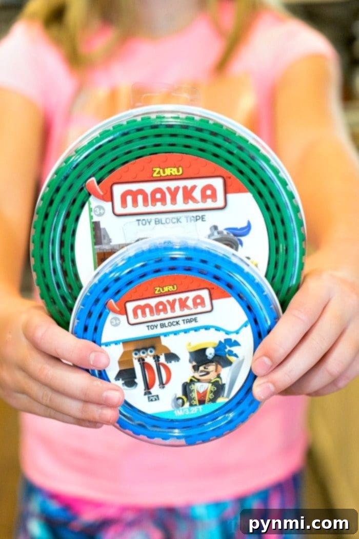 Toy block tape that's compatible with building bricks you already have at home! Sticky and reusable it's super fun! Close-up of Mayka toy block tape applied to a surface, with LEGO bricks attached.