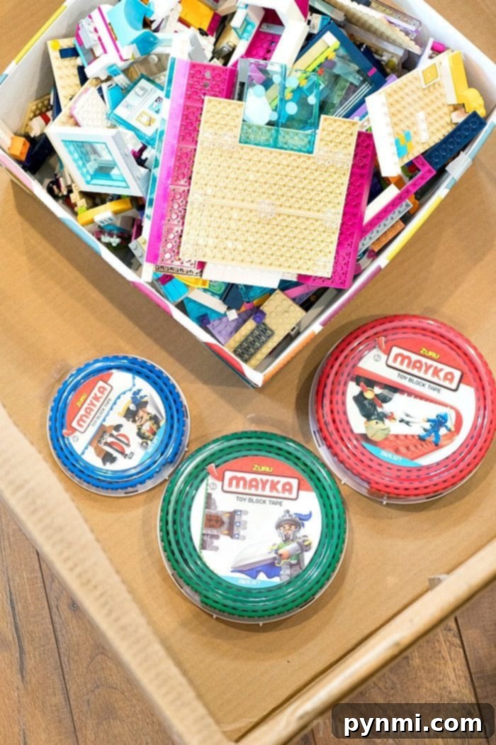 Get ready for more imaginative play with toy block tape that's compatible with building bricks you already have at home! Sticky and reusable it's super fun! Kids hands attaching LEGO bricks to toy block tape, demonstrating ease of use.