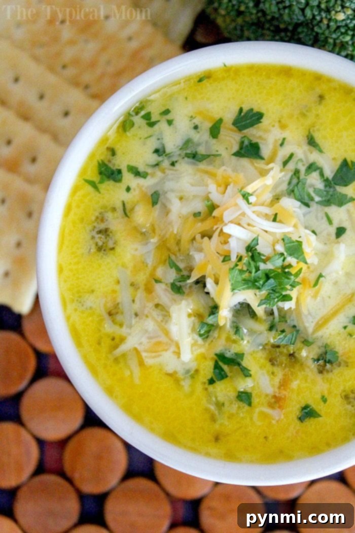 Pressure cooker broccoli cheese soup uses fresh vegetables and turns out creamy and delicious in your Instant Pot every time! Instant Pot, pressure cooker, Instant Pot recipes, soup, broccoli, cheese, creamy. A bowl of creamy Pressure Cooker Broccoli Cheddar Soup topped with shredded cheese and fresh parsley, served alongside crispy crackers.