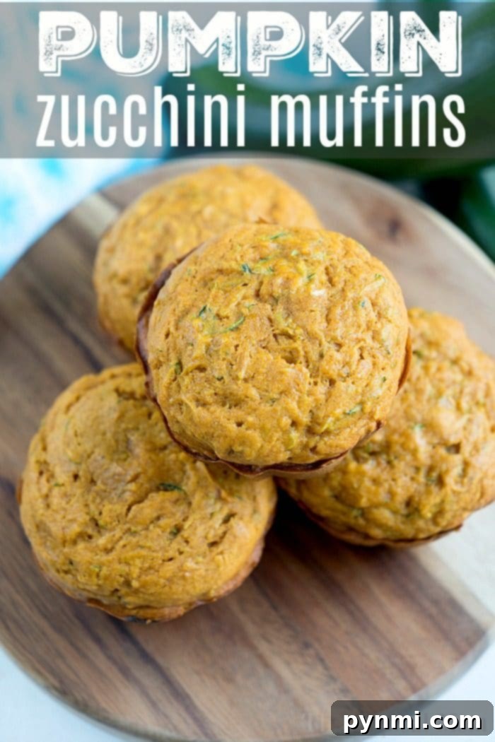 Perfectly Baked Pumpkin Zucchini Muffins. Golden-brown Pumpkin Zucchini Muffins on a cooling rack, freshly baked.
