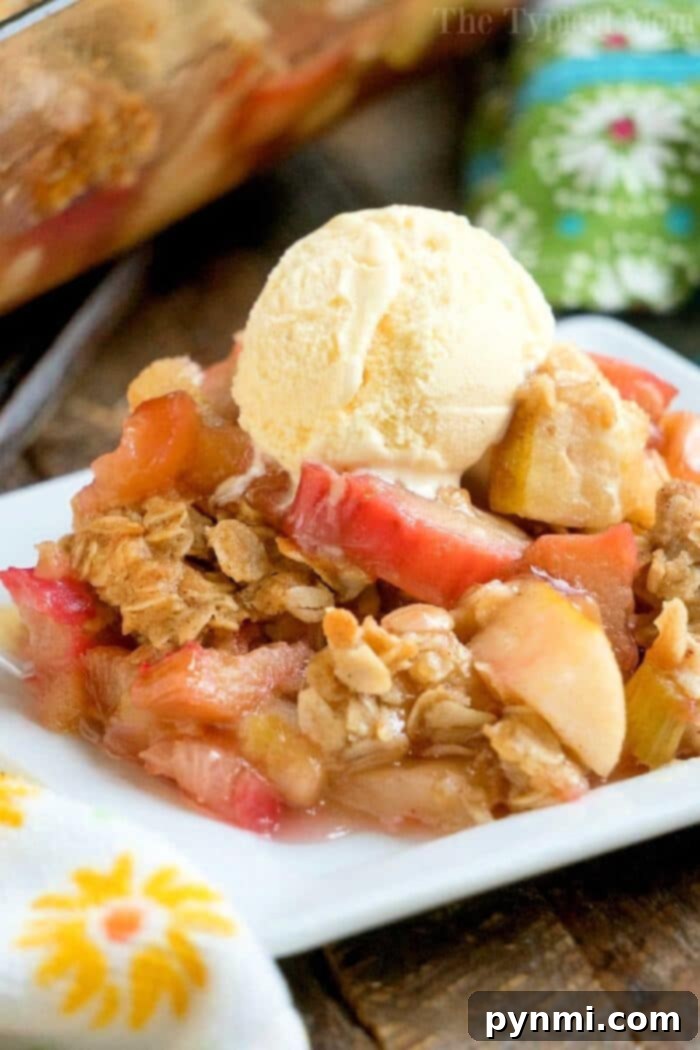 Amazing Apple Rhubarb Crisp with Golden Oatmeal Topping A beautifully baked Apple Rhubarb Crisp, golden brown and bubbling, ready to be served. The texture of the oat topping is visible, inviting a taste.