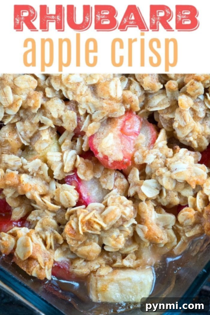 Delicious Rhubarb Apple Crisp with Crunchy Oatmeal Topping Close-up of the perfectly golden-brown oatmeal topping on a rhubarb apple crisp, highlighting its crunchy texture and the delicious fruit peeking through.