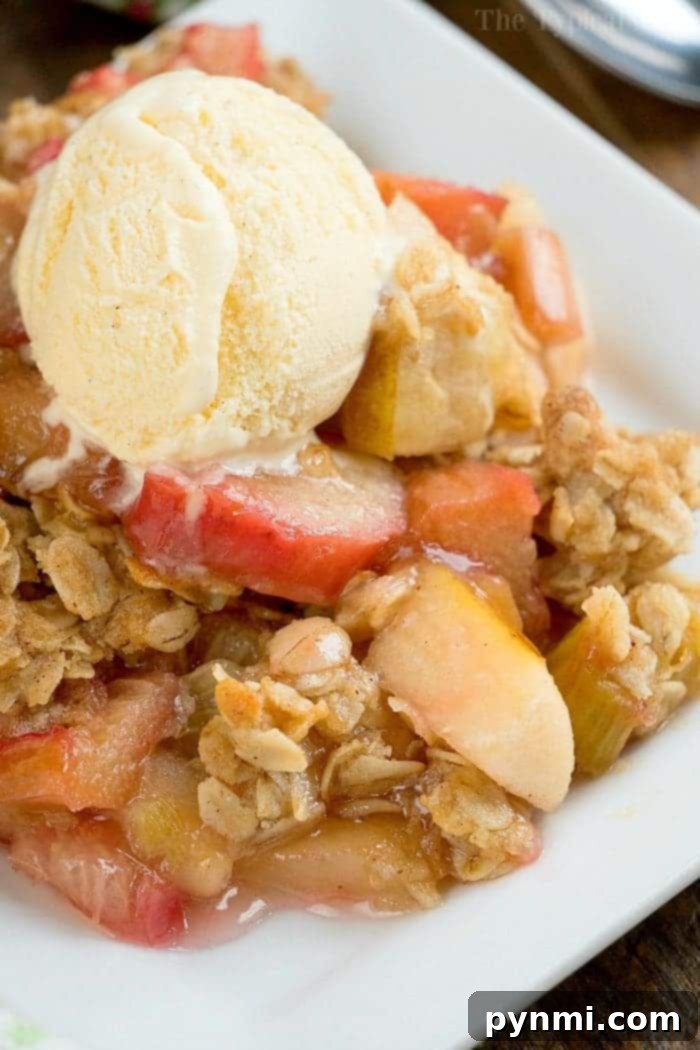Hearty and Inviting Apple Rhubarb Crisp A large baking dish brimming with a freshly baked apple rhubarb crisp, showcasing the appealing golden topping and the rich fruit filling beneath. It looks ready for a large gathering.