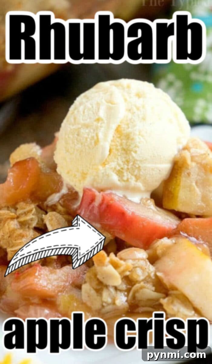 Sweet and Tangy Rhubarb Apple Crisp 3 A close-up shot of a baked apple rhubarb crisp in a white dish, showcasing the vibrant fruit filling and the golden, textured topping. The dessert looks inviting and comforting.