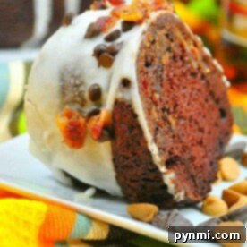 A slice of chocolate rum Bundt cake with white icing, chocolate chips, and sprinkles graces the plate.