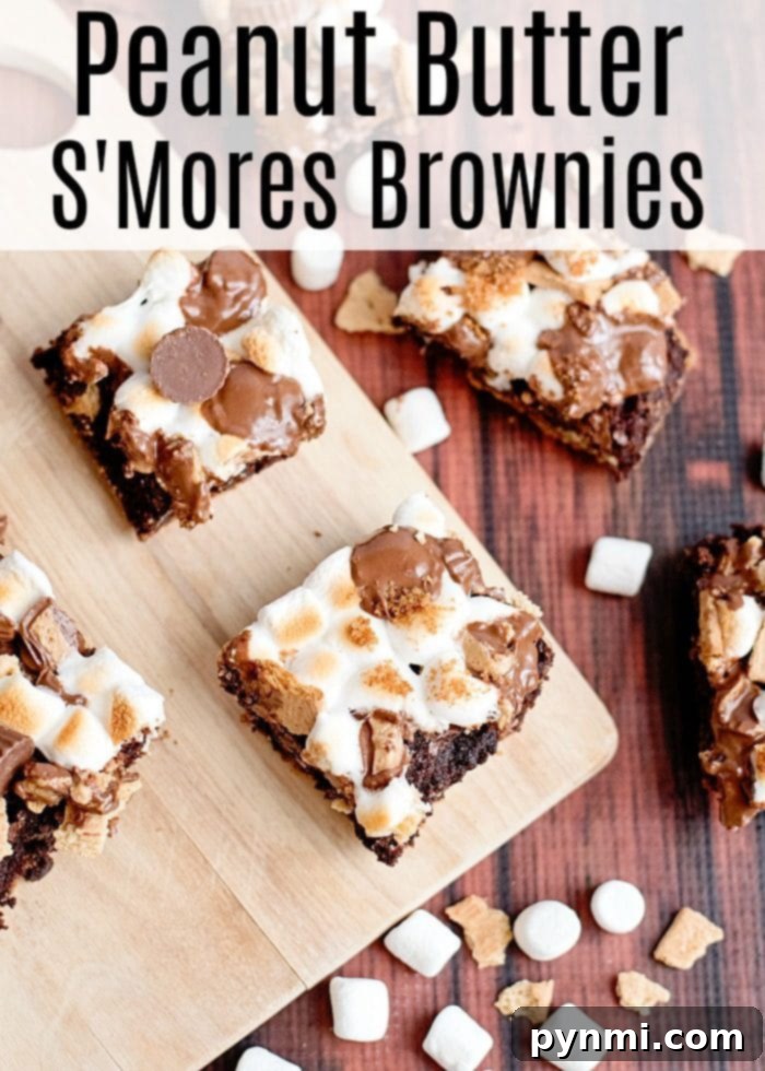Smore brownies with peanut butter cups are to die for! If you've never jazzed up a regular box of brownie mix for dessert you should. You'll be the hero of your house! #peanutbutter #brownies #marshmallow #smores S'mores brownies with peanut butter cups, melted marshmallows, and chocolate
