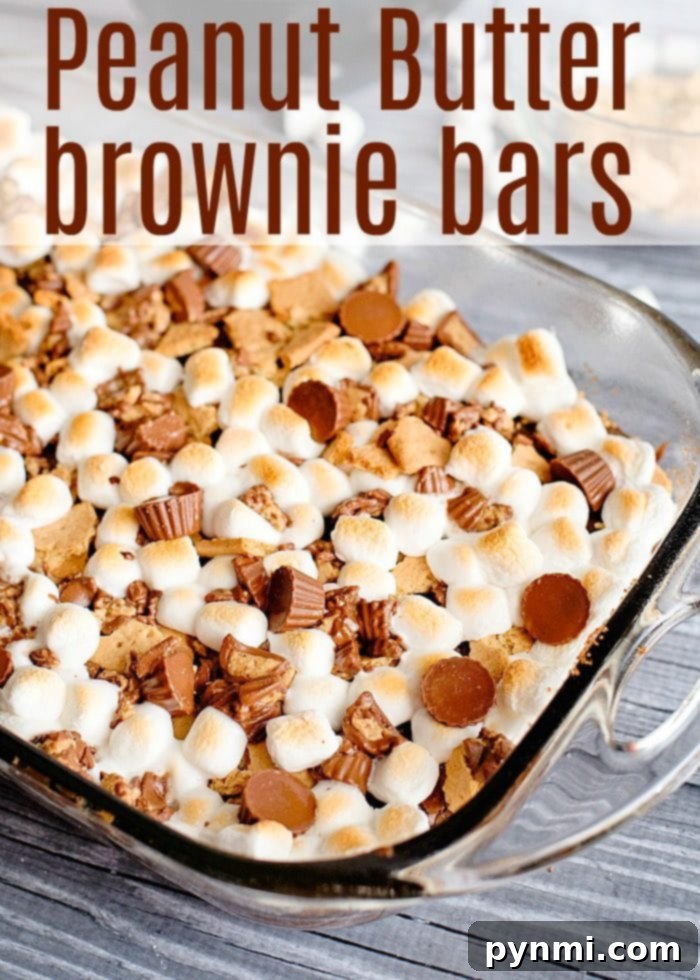 Peanut butter cup smore brownies are to die for! If you've never jazzed up a regular box of brownie mix for dessert you should. You'll be the hero of your house! #peanutbutter #brownies #marshmallow #smores Peanut Butter Cup S'mores Brownies with a close-up on melted chocolate and topping