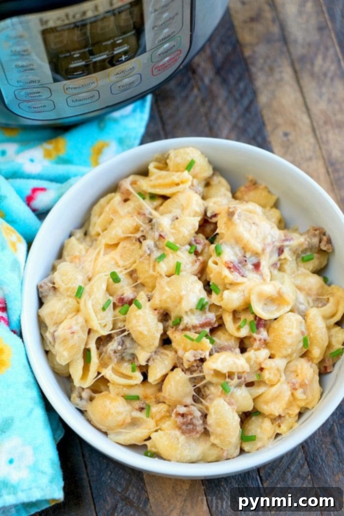 Meat lovers pressure cooker mac and cheese recipe is creamy and filled with bacon and sausage! A hearty Instant Pot dinner anyone will love for sure. #instantpotrecipes #pressurecooker #macandcheese #macaroniandcheese #meatlovers #sausage #ninjafoodi #ninjafoodirecipes #bacon #pasta #macaroni #dinner #thetypicalmom Pressure Cooker Mac and Cheese
