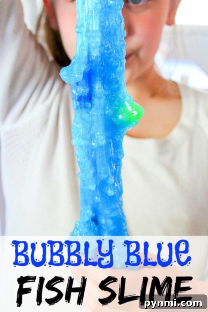 Vibrant blue borax-free fish slime with small plastic fish swimming inside, perfect for kids' creative play