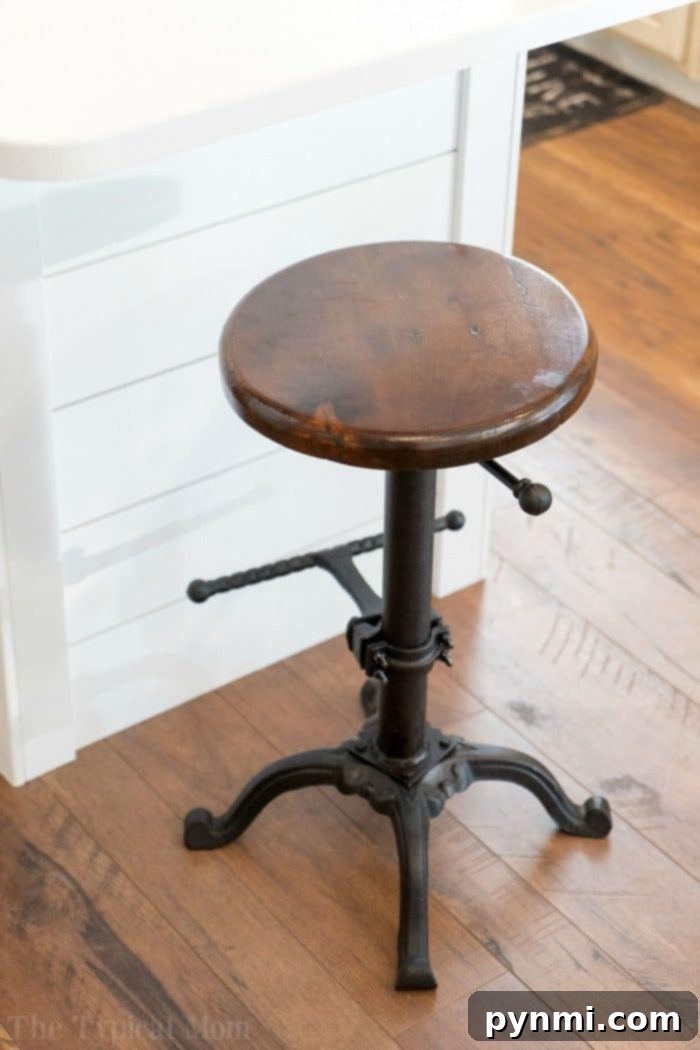 We love our Farmhouse bar stool! Come see how we transformed our dark kitchen into a bright room with fun Farmhouse kitchen decor and a barn door pantry everyone loves! #farmhouse #decor #masonjar #barndoor #decorating #kitchen #table #lights #chairs Farmhouse Bar Stools for Kitchen Island
